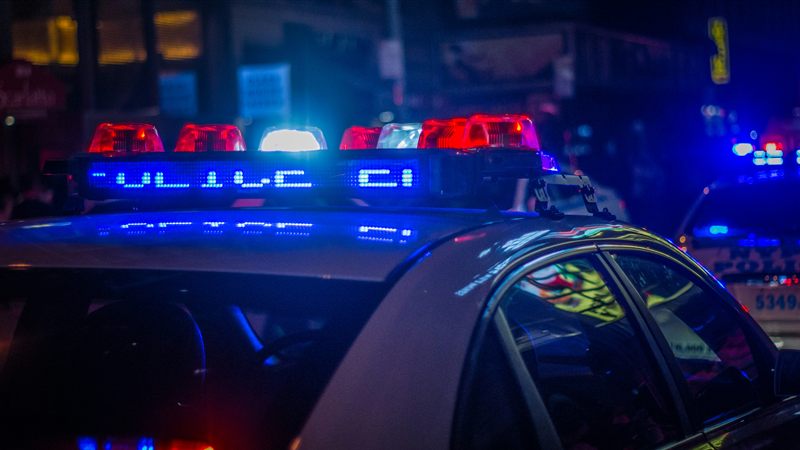 Colorado police car with red and blue lights flashing at night